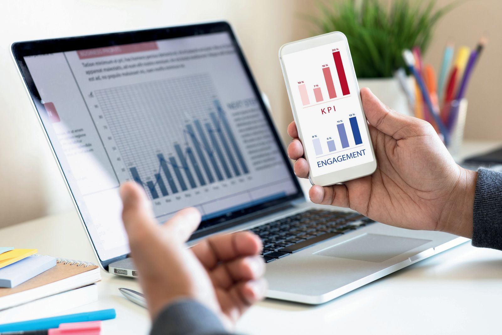 Market analytics charts on a laptop and smartphone
